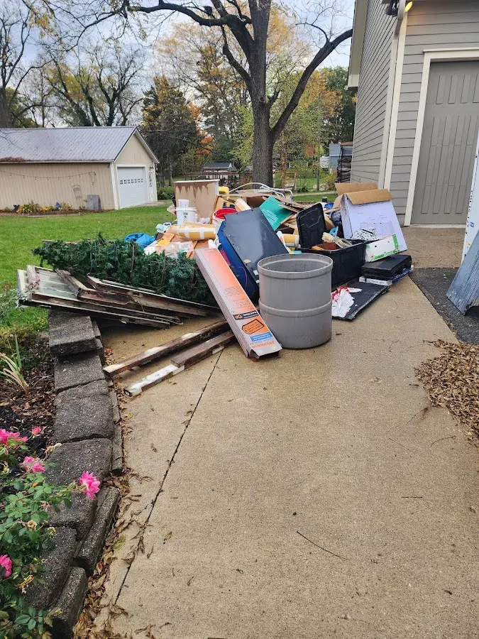 Dumpster being loaded with debris for Estate Cleanout Dumpster Rental in Dove Valley